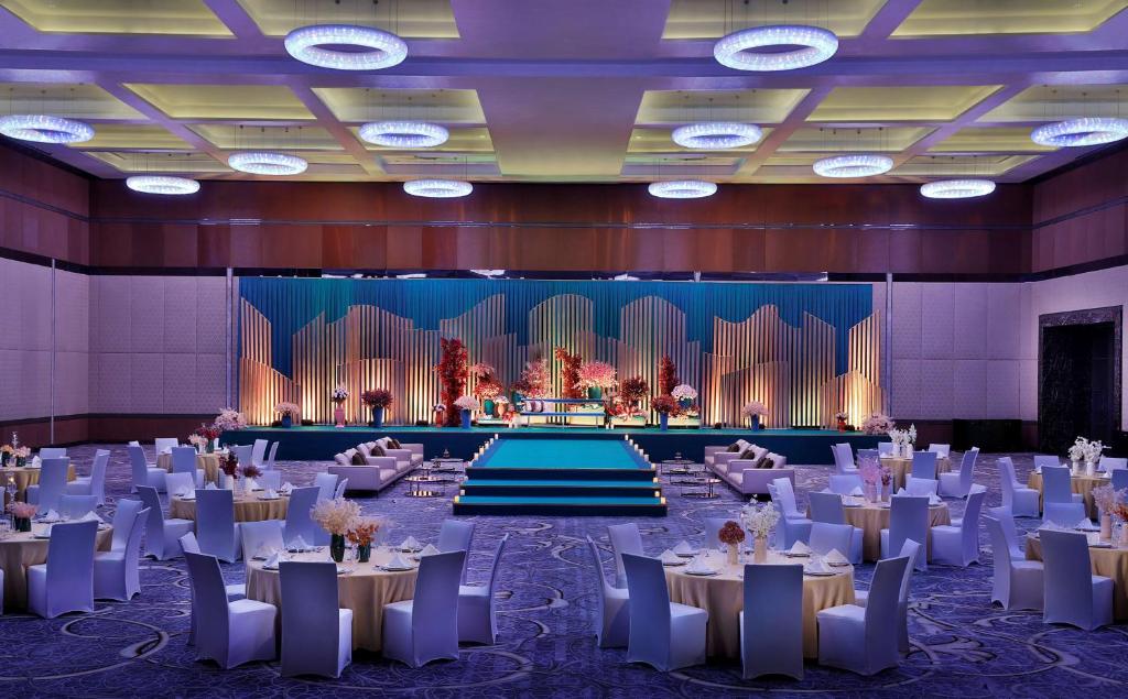 a banquet hall with tables and chairs and a stage at Conrad Abu Dhabi Etihad Towers in Abu Dhabi