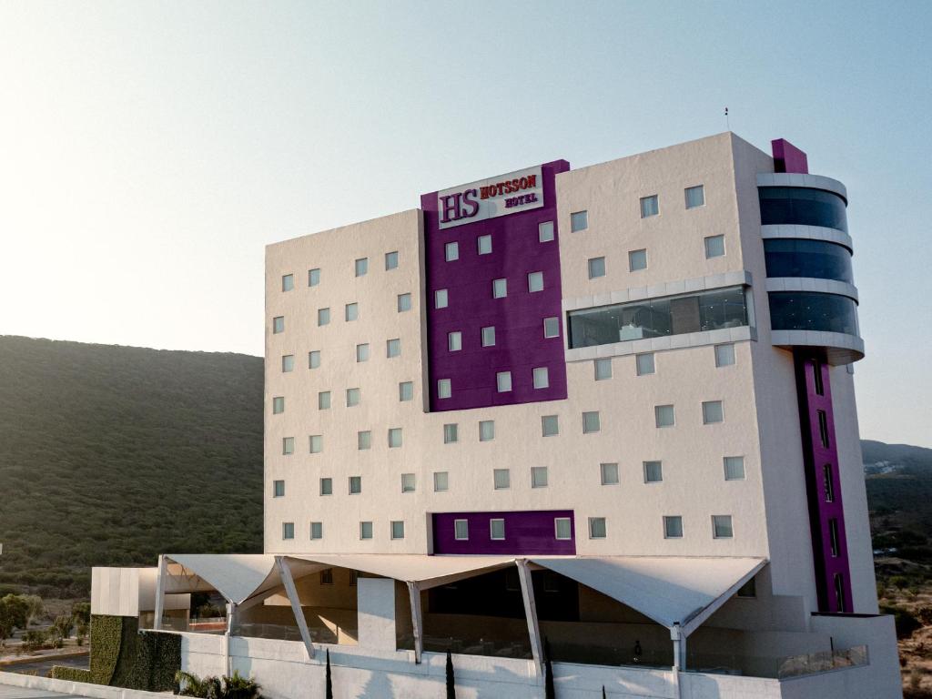 a hotel with a purple and white building at HS HOTSSON Hotel Queretaro in Querétaro