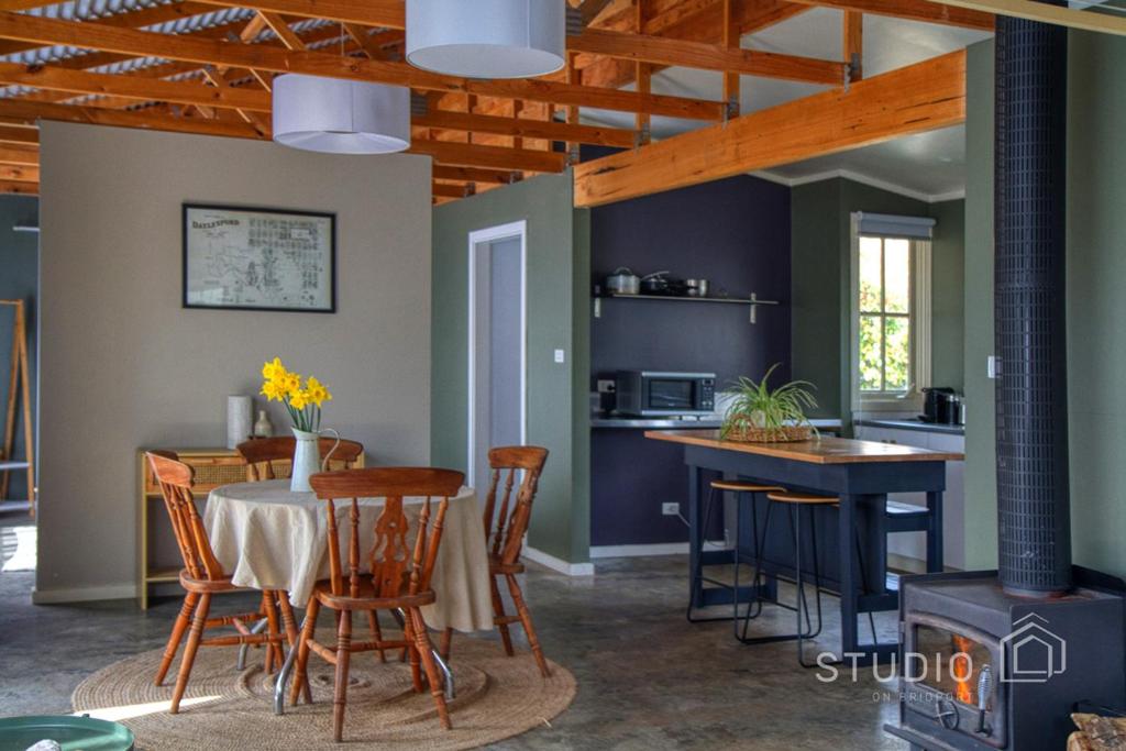 a kitchen and dining room with a table and chairs at Studio on Bridport in Daylesford