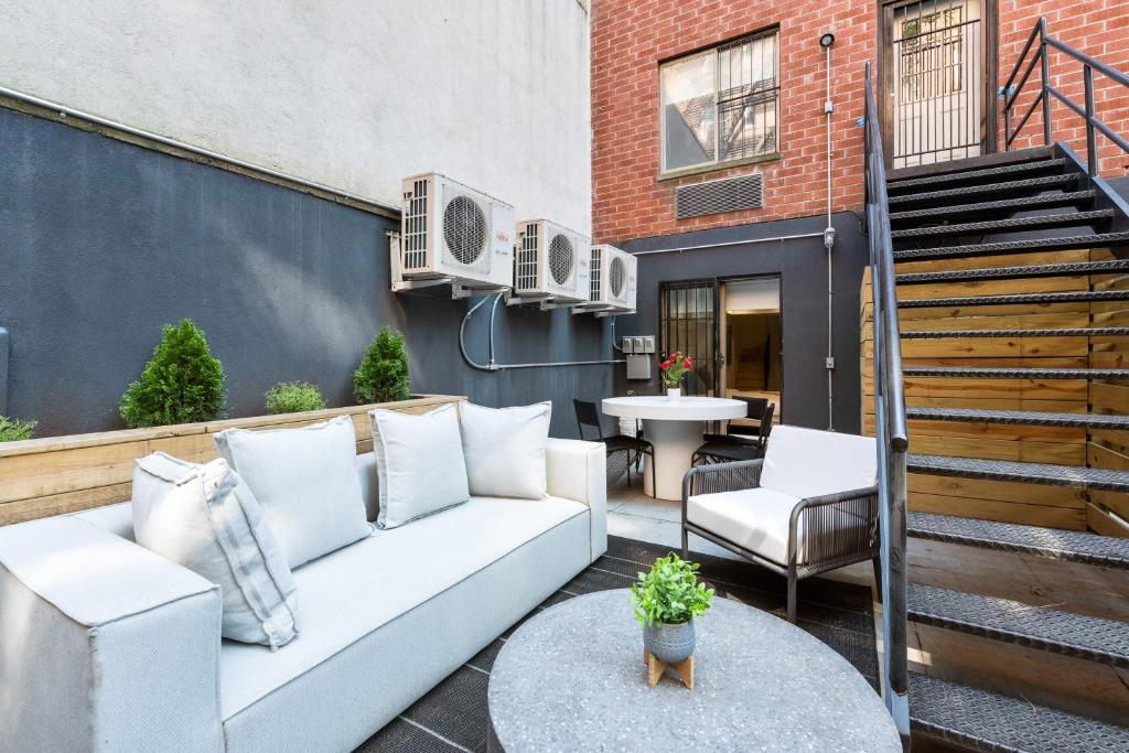 a patio with a white couch and a table at Unbeatable 3BR with Private Patio in Upper East Side in New York