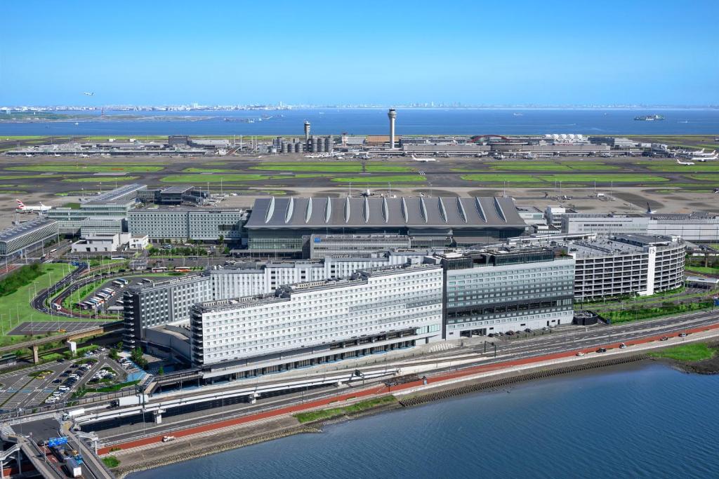 an aerial view of a large building next to the water at Villa Fontaine Grand Haneda Airport in Tokyo