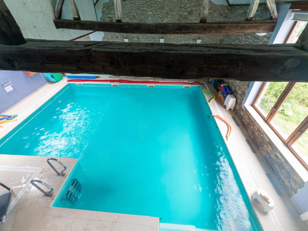an overhead view of a swimming pool in a house at Stunning home for 5 adults with indoor pool in Esneux
