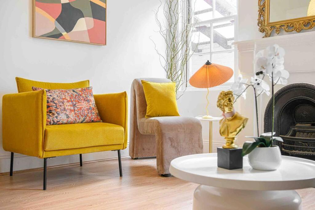 a living room with a yellow chair and a table at Victorian Dream Terrace CBD in Sydney