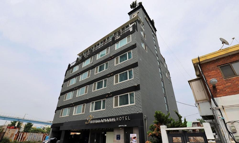 a tall gray building with a sign on it at Incheon Wolmido Stellamaris Hotel in Incheon