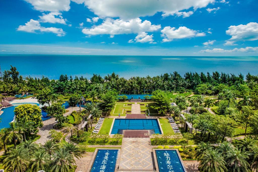 an aerial view of the resort with the ocean in the background at Hilton Haikou Meilan in Haikou