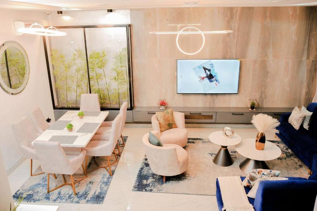 拉各斯的住宿－Luxury 4bed Harris Drive Lekki，客厅配有沙发和桌椅