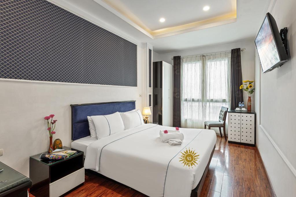 Postel nebo postele na pokoji v ubytování Golden Sun Hotel