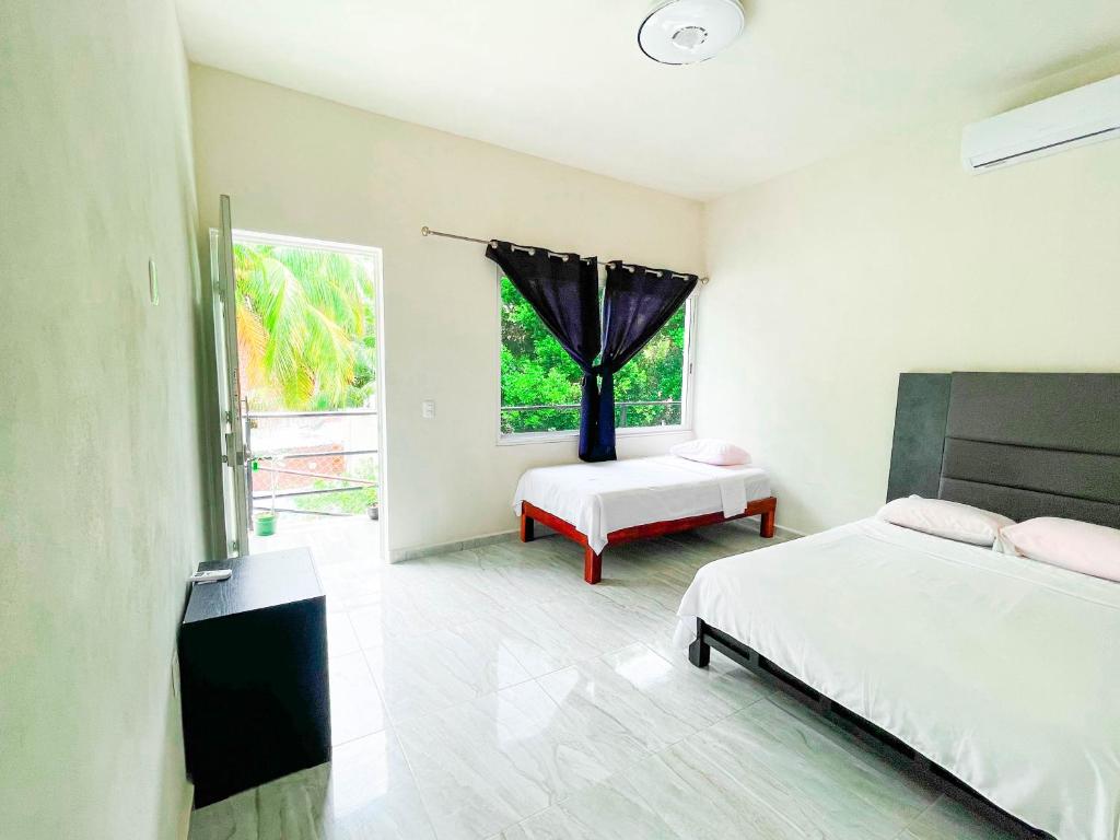 Postel nebo postele na pokoji v ubytování Hotel Vias Maya Bacalar