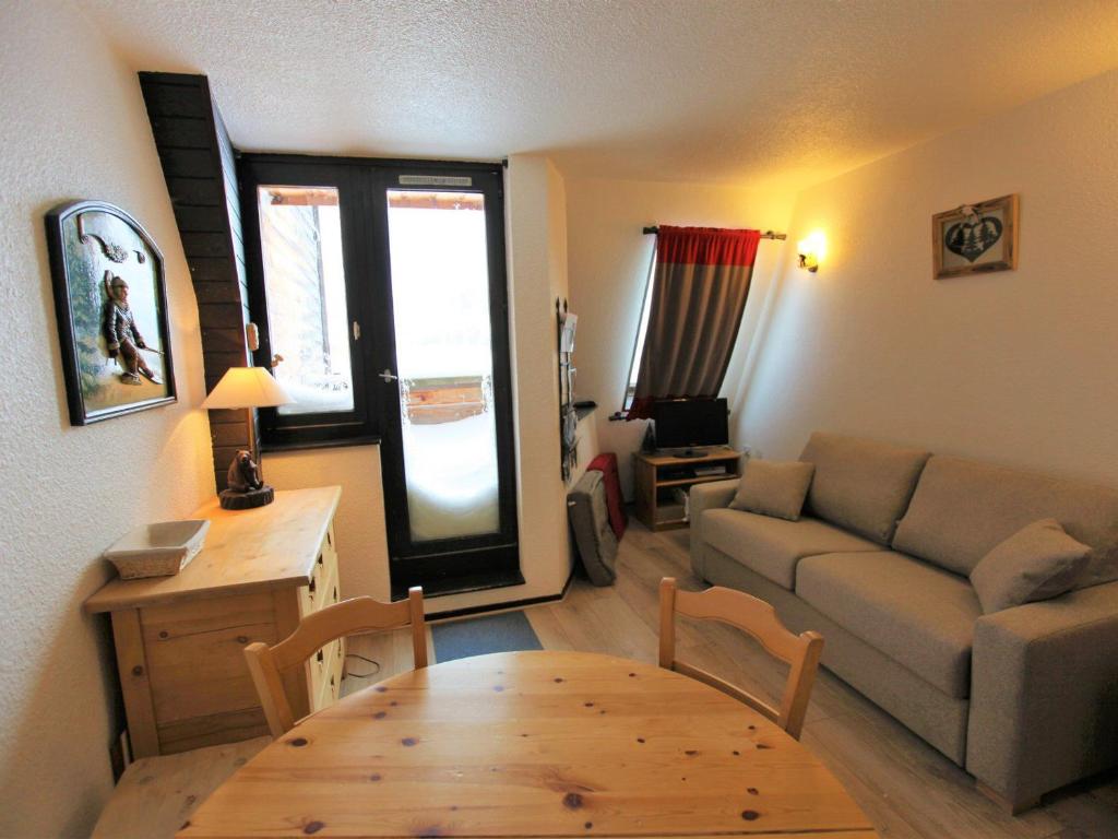 a living room with a couch and a table at Studio Avoriaz, 1 pièce, 4 personnes - FR-1-314-170 in Morzine