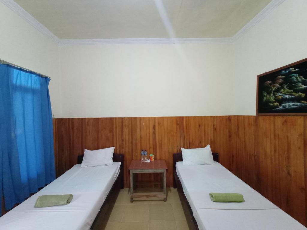 Postel nebo postele na pokoji v ubytování Tangkoko Lodge