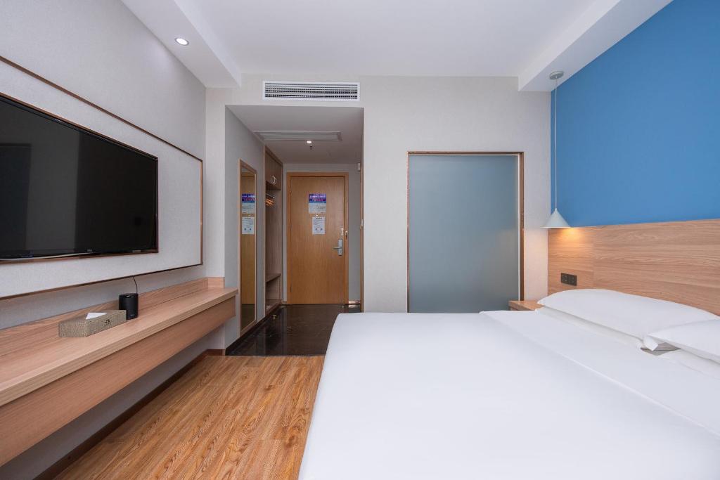 Postel nebo postele na pokoji v ubytování Future Shangju Hotel