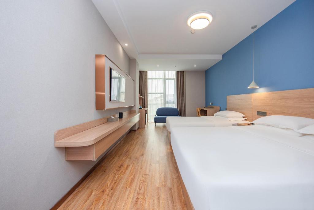 Postel nebo postele na pokoji v ubytování Future Shangju Hotel