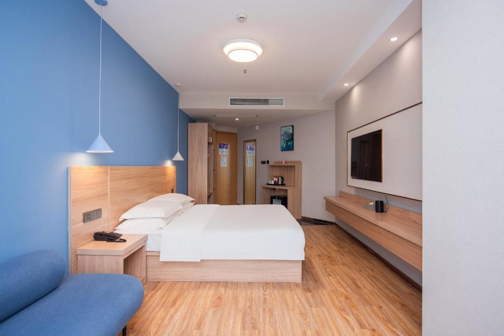 Postel nebo postele na pokoji v ubytování Future Shangju Hotel