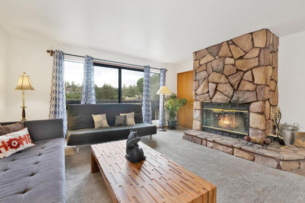 a living room with a couch and a fireplace at 2341-Bear Meadow Woods Condo condo in Big Bear Lake