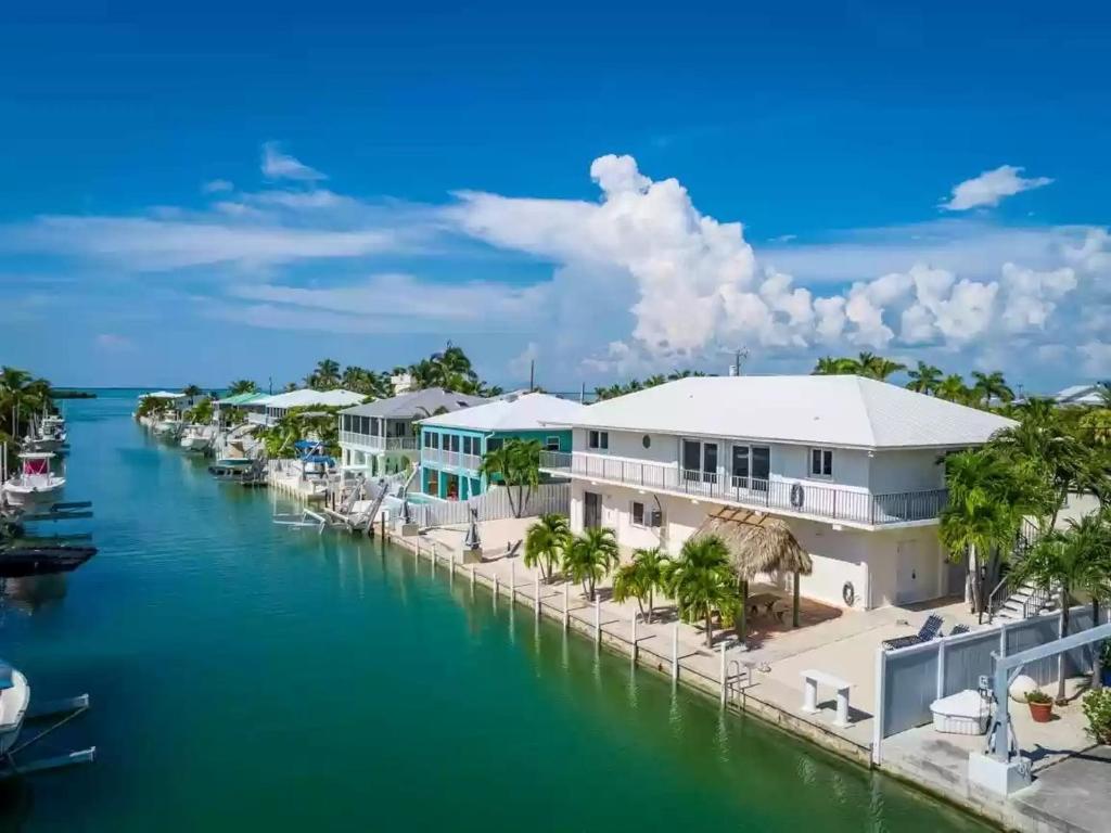 a row of houses on the water next to a marina at Relaxing 2 2 Get Away in the Lower Keys! home in Summerland Key