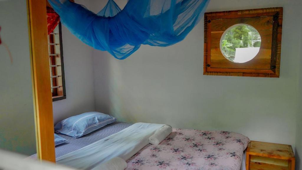 a small bedroom with a bunk bed and a window at Steven and Dayness homestay in Lushoto