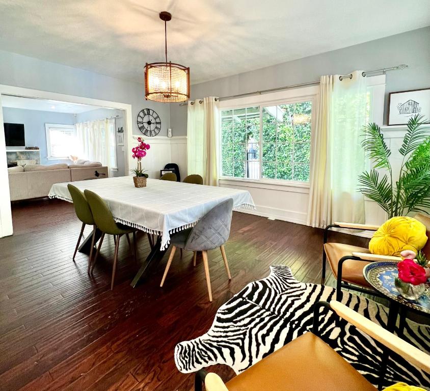 a dining room with a table and a zebra print rug at Hollywood house with parking - walk to attractions in Los Angeles