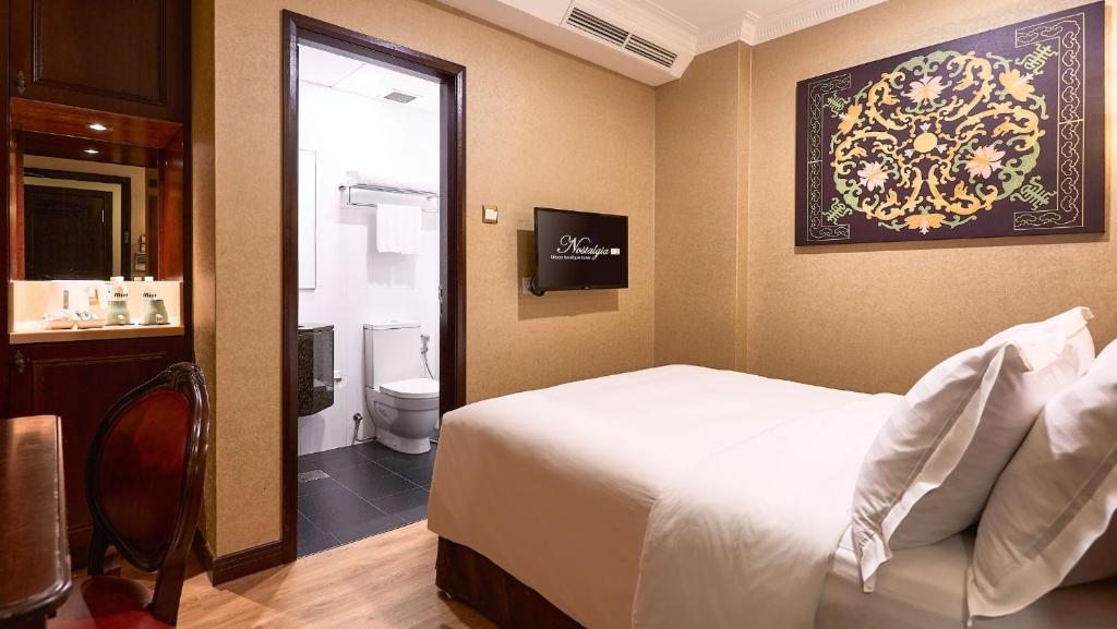 Postel nebo postele na pokoji v ubytování Nostalgia Hotel