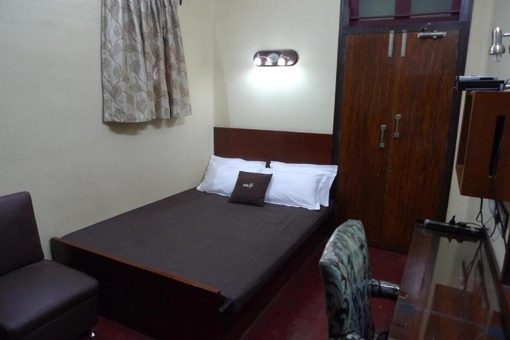 Postel nebo postele na pokoji v ubytování The Kei Suites