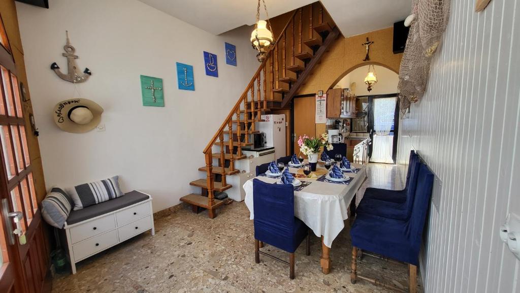 a dining room with a table and blue chairs at Perlica in Vodice