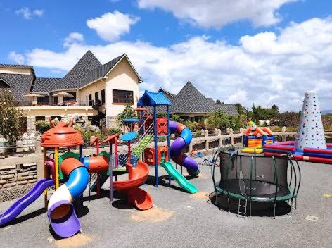 a playground with a bunch of different colored slides at Kiikalloh Grand Resort in Machakos