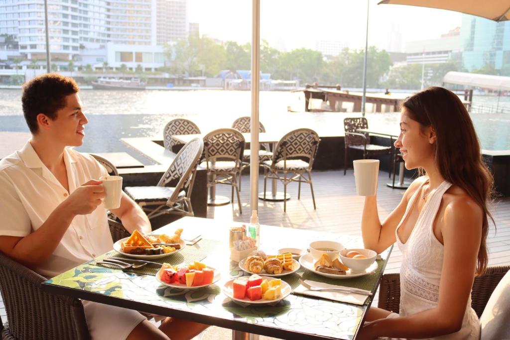 A breakfast table beside broad windows overlooking the river.