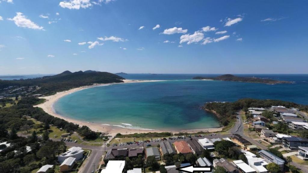 an aerial view of a beach and the ocean at Fingal Beach Shack in Fingal Bay