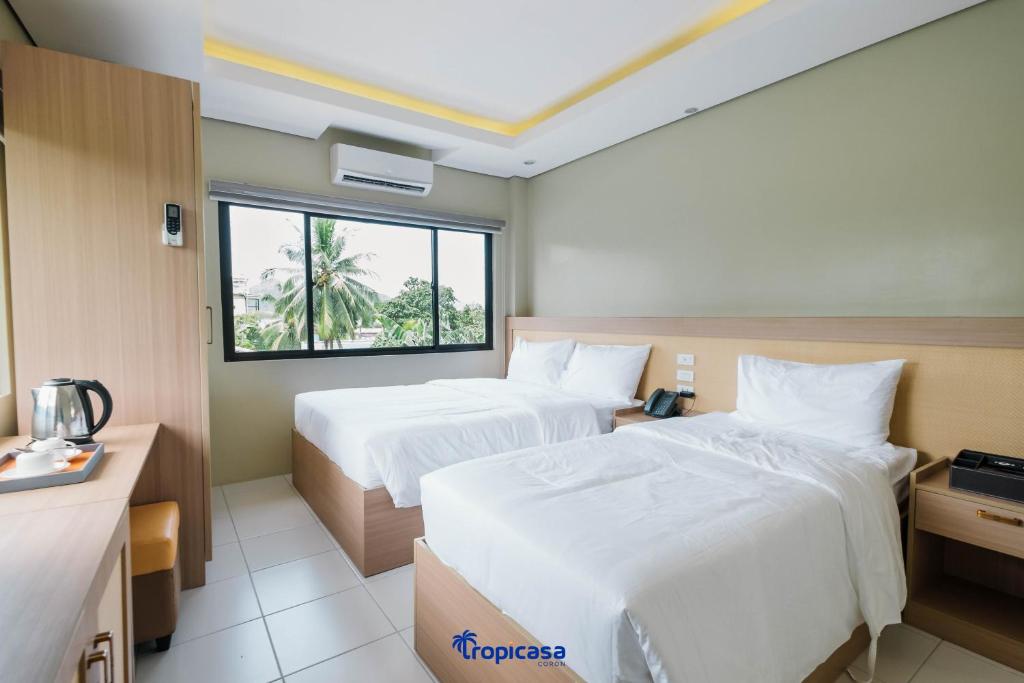 Postel nebo postele na pokoji v ubytování Tropicasa Hotel