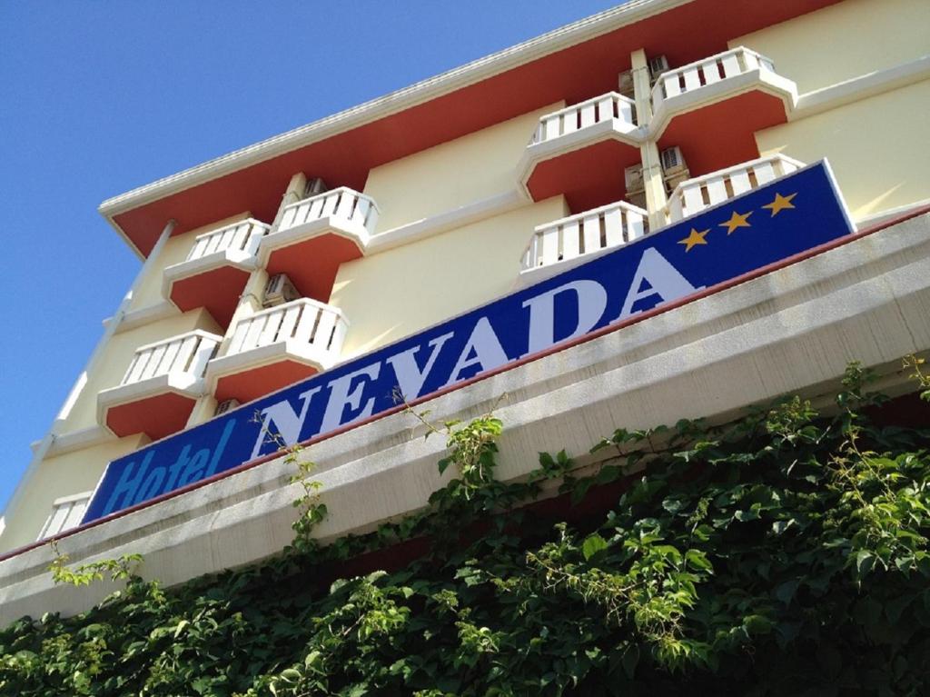 a sign on the side of a building at Hotel Nevada in Bibione