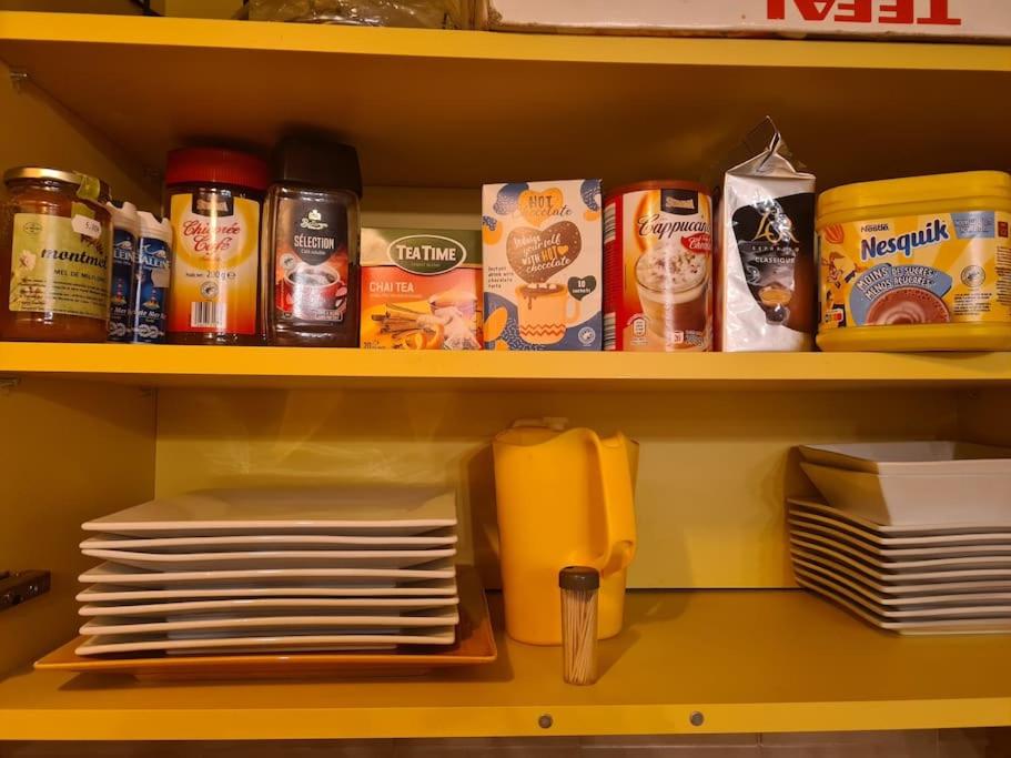 a shelf with plates and other food on it at La maison du bonheur in Caumont-sur-Durance