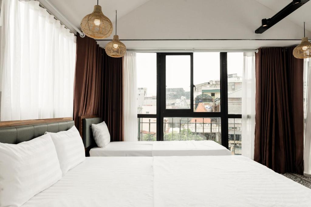 Postel nebo postele na pokoji v ubytování Tabalo Hostel Hanoi