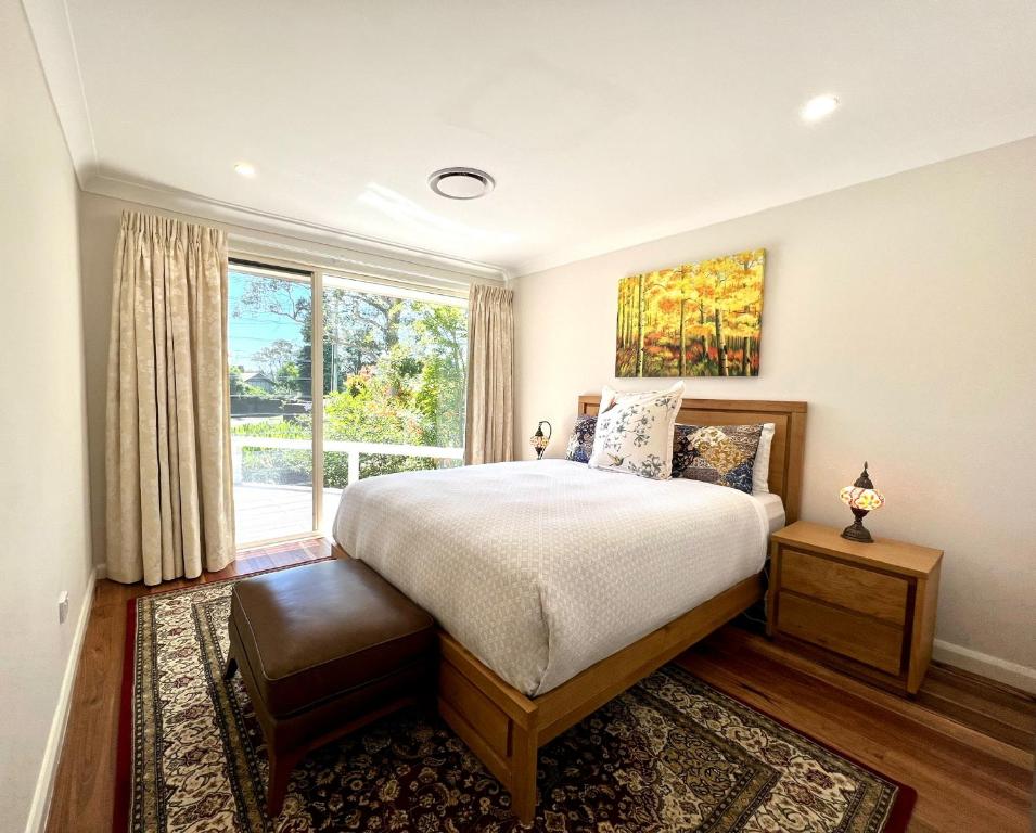 a bedroom with a large bed and a window at Birdwood Guesthouse in Blackheath