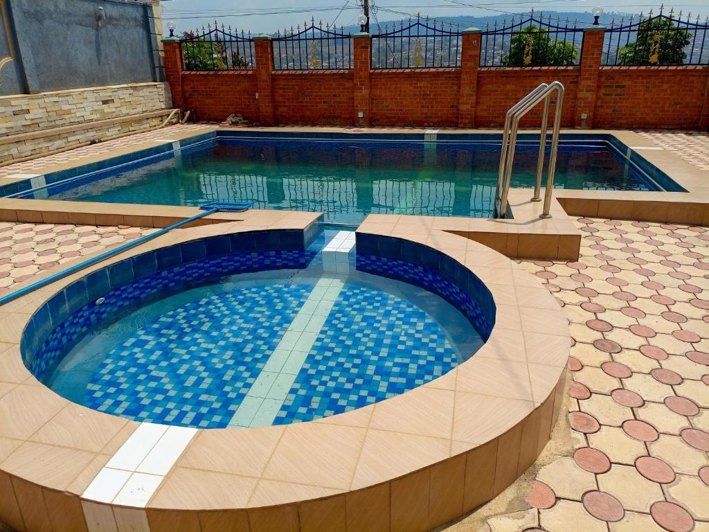 a large swimming pool with blue water at Kigali Nice Apartment in Kigali