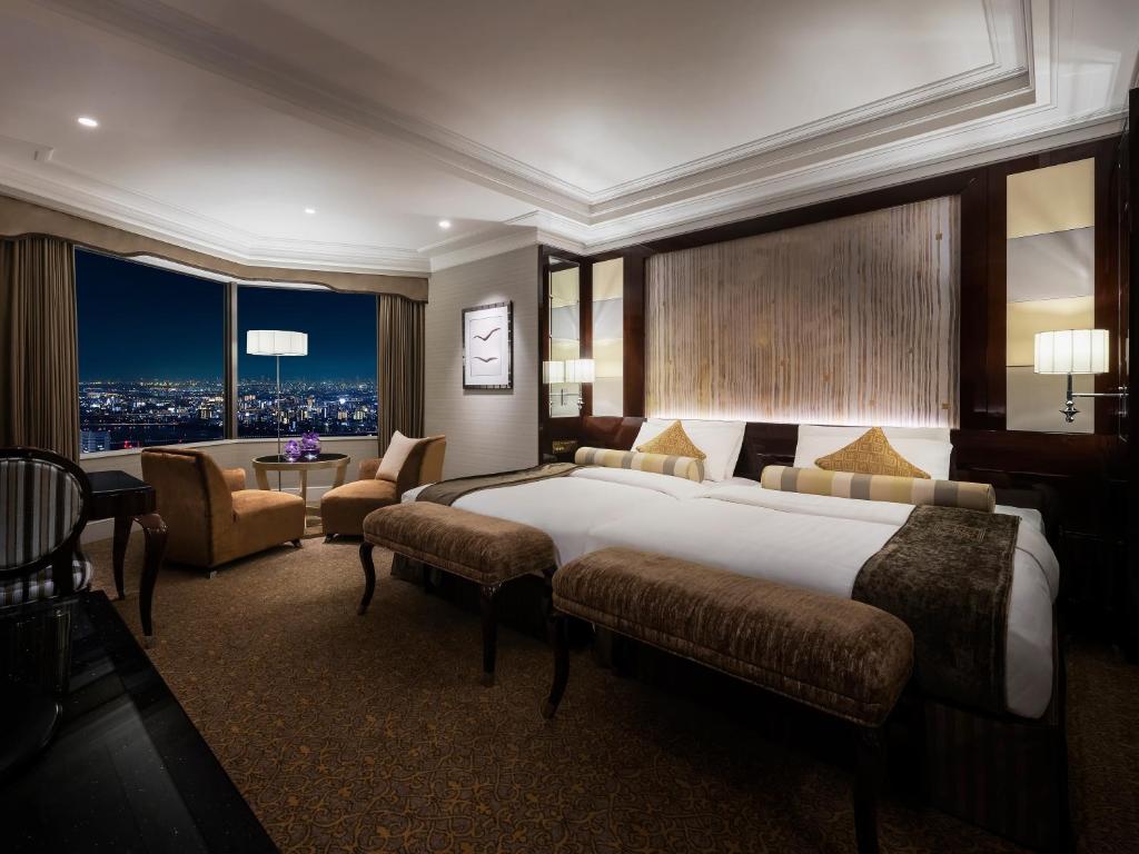 Postel nebo postele na pokoji v ubytování Hotel Hankyu International