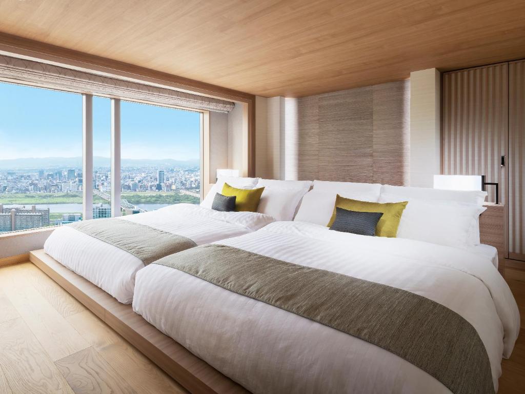 Postel nebo postele na pokoji v ubytování Hotel Hankyu International