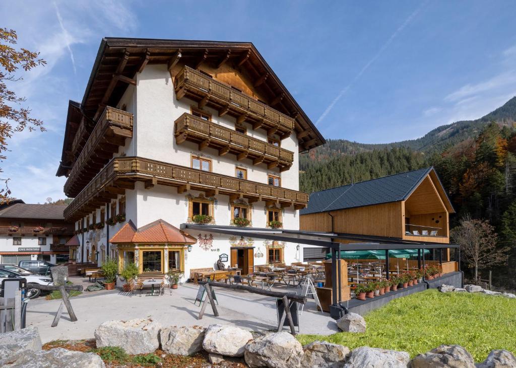 a large building with a playground in front of it at Gasthof zur Post in Hinterriss