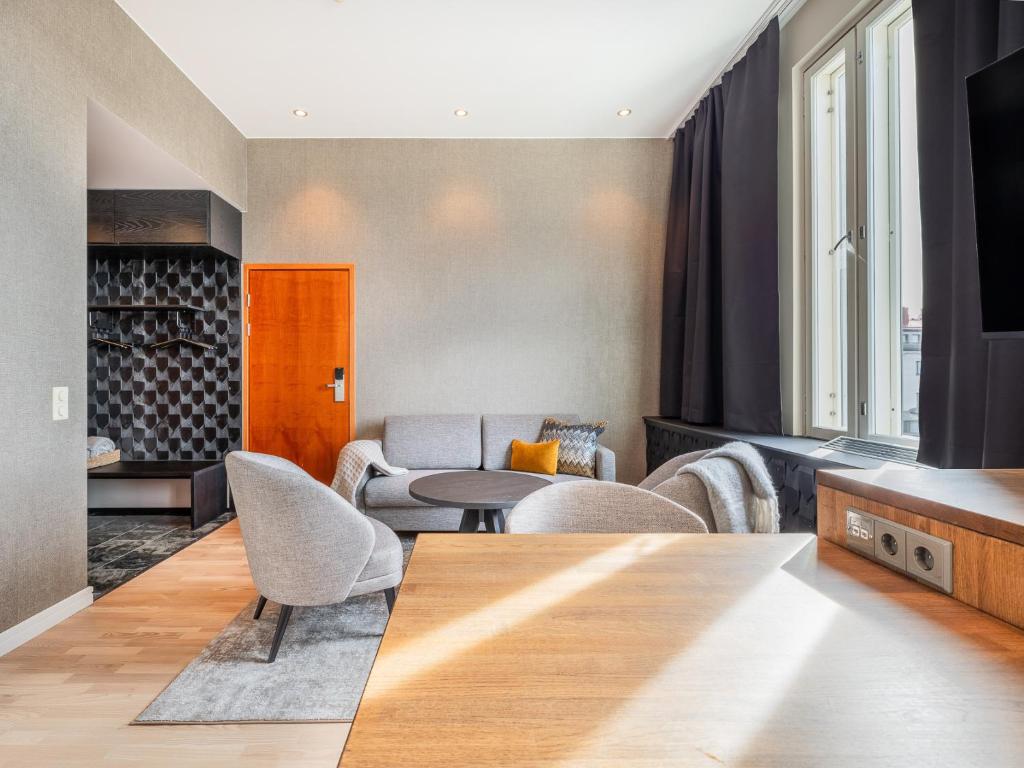 a living room with a table and chairs at Santa's Hotel Santa Claus in Rovaniemi