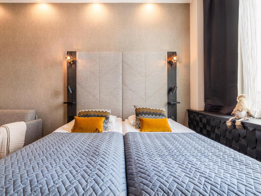two beds sitting next to each other in a bedroom at Santa's Hotel Santa Claus in Rovaniemi