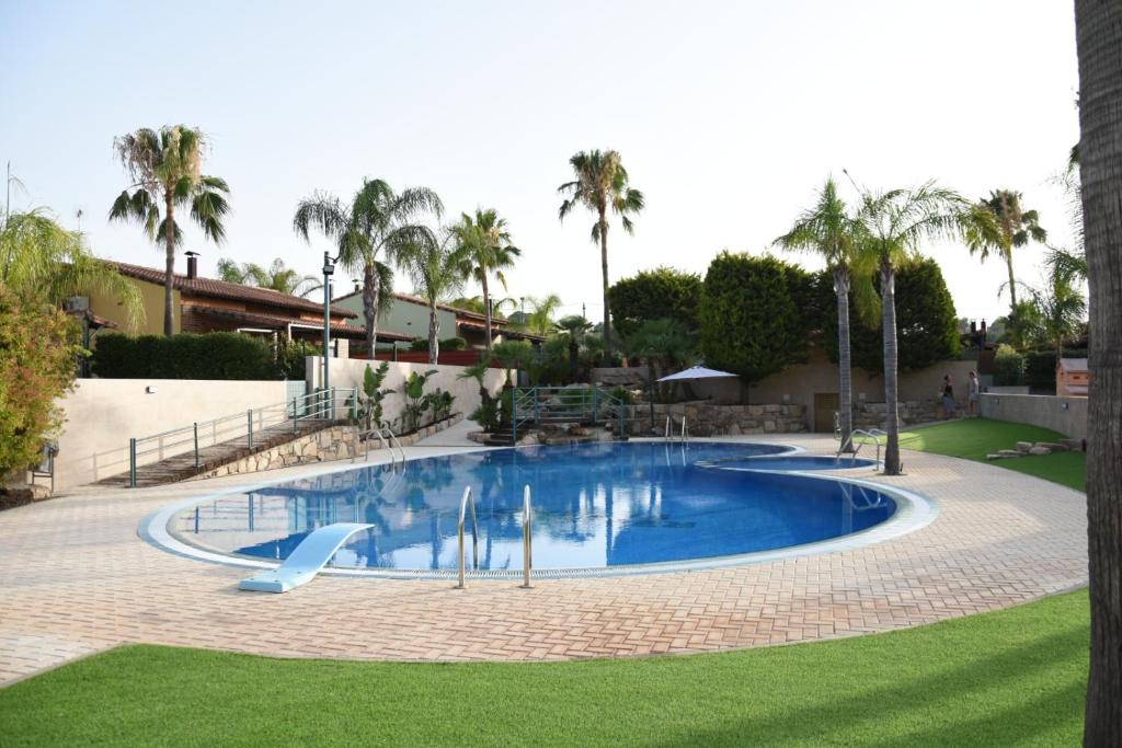 a large blue pool with a slide in a yard at Holiday Home Valencia in Riba-Roja De Turia