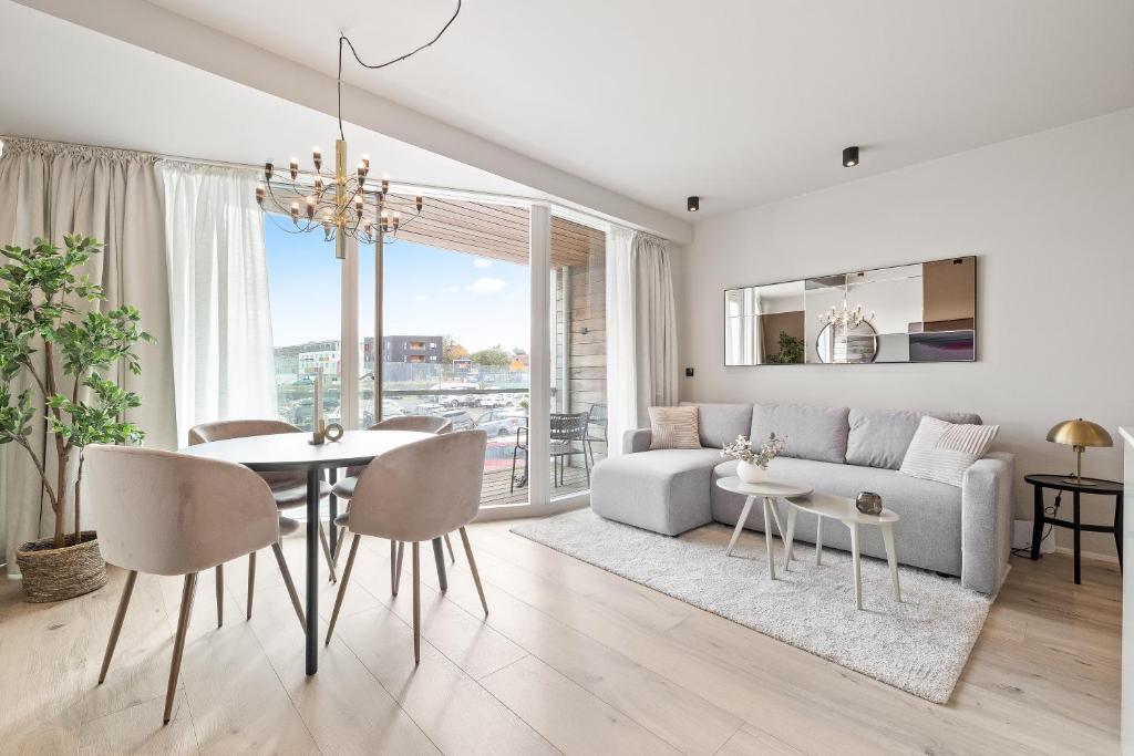 a living room with a couch and a table at Brand New Downtown Harbor Apartment in Reykjavík