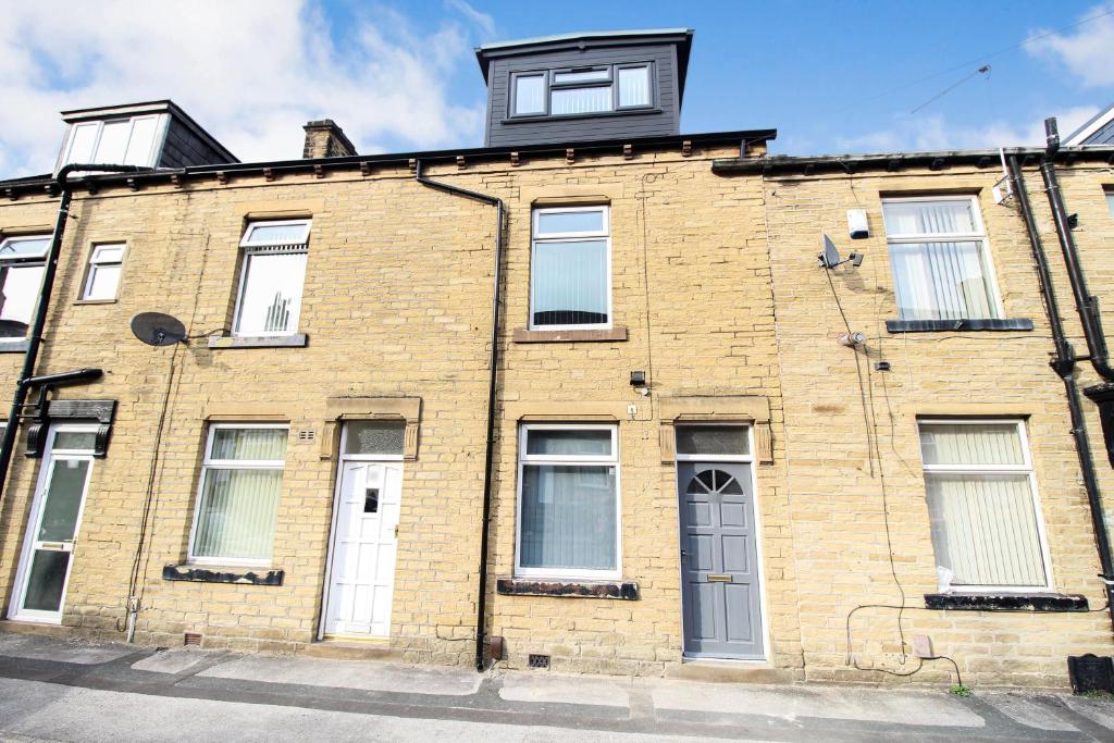 a brick building with a window on top of it at Remarkable 4-Bed House in Bradford in Bradford
