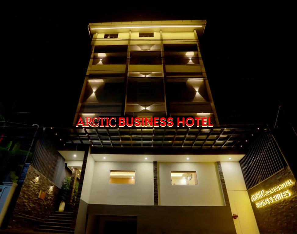 an office building with a sign that reads electric business hotel at Arctic Business Hotel in Cochin