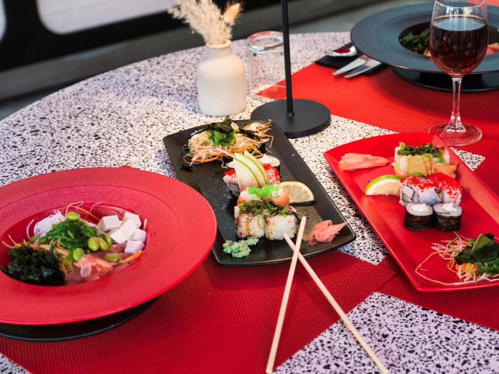 a table with plates of food on a red table at Leonardo Cypria Bay in Paphos