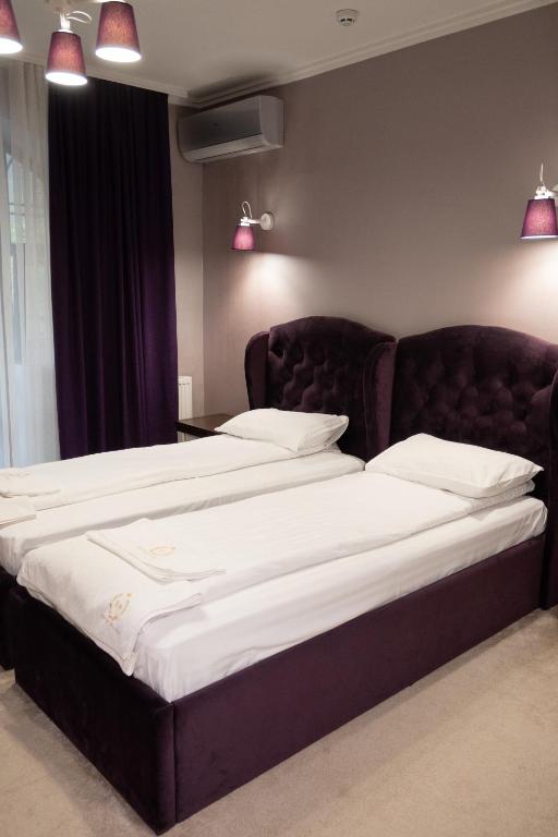 Postel nebo postele na pokoji v ubytování River Stone Hotel