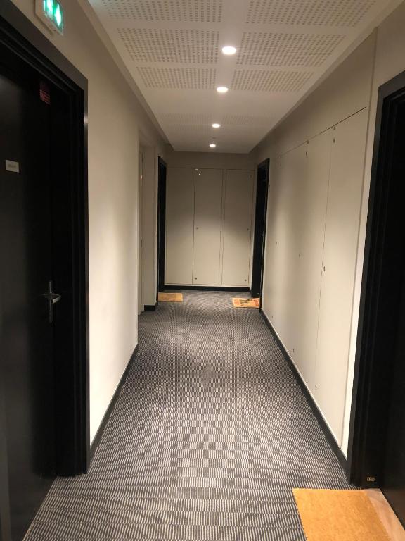 an empty hallway with white lockers in a building at Jolie chambre à Nanterre Préfecture proche La Défense Aréna Campus SNCF et Paris in Nanterre