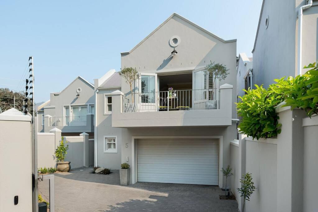 a large white house with a garage at The Tram Home Stay in Franschhoek