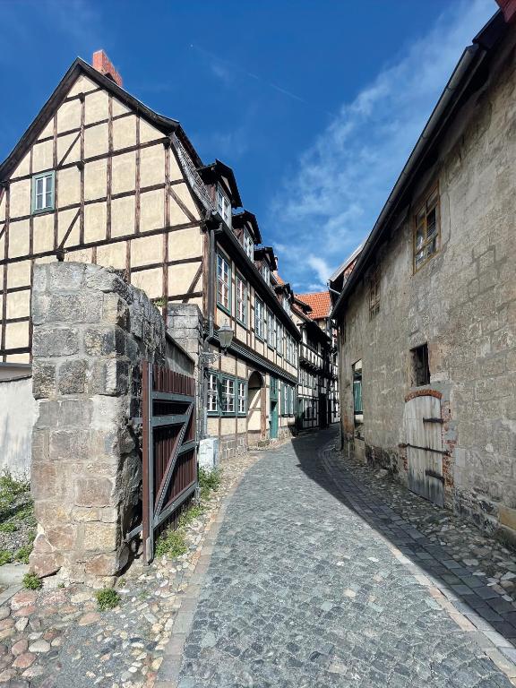 an alley in an old stone building with a gate at Ferienhaus Schuhhof in Quedlinburg