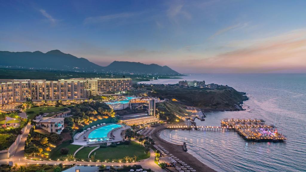 an aerial view of a resort and the ocean at night at Elexus Hotel Resort & Spa & Casino in Kyrenia