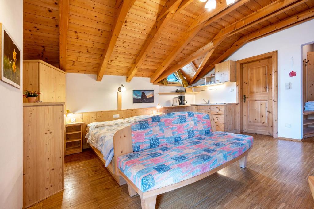 una camera con letto e soffitto in legno di Lindenhof Apt 3 a Vandoies