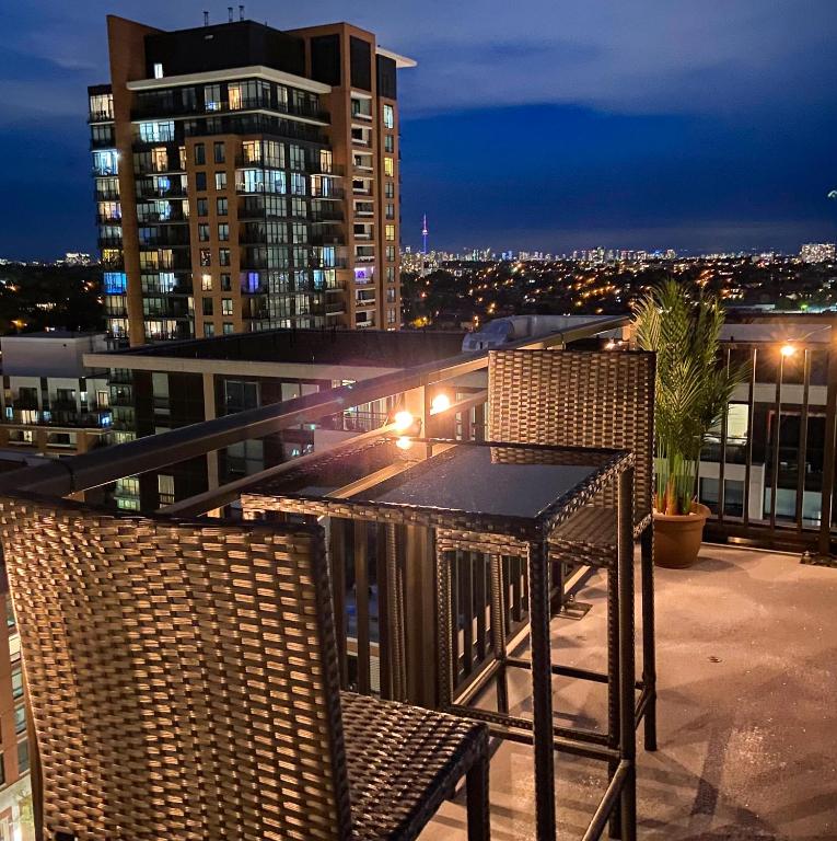 a table and two chairs on a balcony at night at The Splendid - Luxury 1BR Uptown Toronto in Toronto